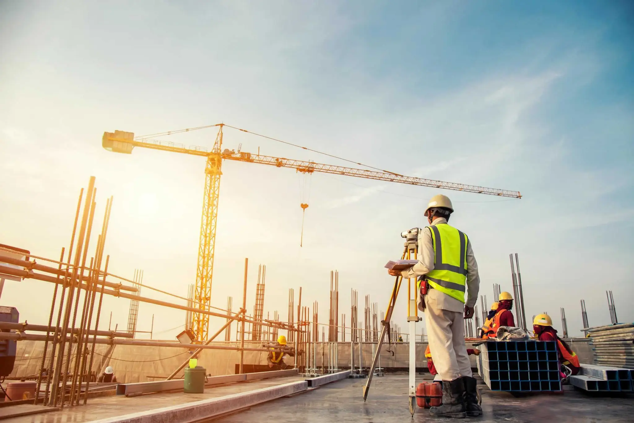 Construction site with crane and surveyor
